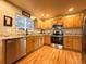 Updated kitchen with stainless steel appliances, granite countertops, wood cabinets and modern finishes at 4049 S Quatar St, Aurora, CO 80018