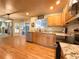 Bright kitchen with stainless steel appliances, granite countertops, hardwood floors and a view to the living room at 4049 S Quatar St, Aurora, CO 80018