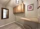 The laundry room has cabinets above a counter and a mirror on the wall at 4049 S Quatar St, Aurora, CO 80018