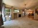 Spacious living room features a cozy fireplace, large windows, and seamless access to the kitchen at 4049 S Quatar St, Aurora, CO 80018