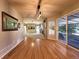 Spacious living room with hardwood floors, sliding glass doors, and a modern chandelier providing natural light at 4049 S Quatar St, Aurora, CO 80018