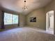 Large primary bedroom boasts vaulted ceilings, a large window, and a view of the en-suite bathroom at 4049 S Quatar St, Aurora, CO 80018