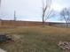 Spacious backyard featuring a wood fence, bare tree, and a gentle sloping lawn at 2201 Sable Blvd # 1007, Aurora, CO 80011