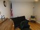 Cozy bedroom with hardwood floors, a futon, and a vintage rolltop desk at 2201 Sable Blvd # 1007, Aurora, CO 80011