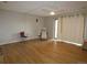 Bright living room features wood-look flooring, a ceiling fan, and sliding glass doors for ample natural light at 2201 Sable Blvd # 1007, Aurora, CO 80011