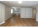Open living area with hardwood floors, neutral walls, a dining set, and access to sliding door at 2201 Sable Blvd # 1007, Aurora, CO 80011
