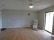 View of living room with hardwood floors, sliding glass door, ceiling fan, and stylish lantern at 2201 Sable Blvd # 1007, Aurora, CO 80011