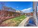 Backyard featuring a lush lawn, garden area with decorative elements, and a barbecue grill at 2409 S Halifax Way, Aurora, CO 80013