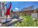 Spacious backyard with well-maintained lawn, patio area, outdoor furniture, and mature trees at 2409 S Halifax Way, Aurora, CO 80013