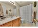 Well-lit bathroom with a single sink vanity and shower with curtain at 2409 S Halifax Way, Aurora, CO 80013