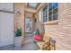 Charming front porch with a brick facade, potted plants, and a cozy bench, creating an inviting entryway at 2409 S Halifax Way, Aurora, CO 80013