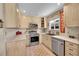 Efficient kitchen design with stainless steel appliances, light wood cabinets, and durable flooring at 2409 S Halifax Way, Aurora, CO 80013