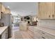 Open concept kitchen flowing into the dining and living room areas at 2409 S Halifax Way, Aurora, CO 80013