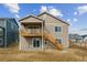 Back of home featuring a wooden deck, stairs, and a partially finished yard at 39202 Clymer St, Elizabeth, CO 80107