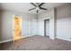 A stylish bedroom features an ensuite bathroom and a closet with sliding doors at 7928 E 54Th Pl, Denver, CO 80238