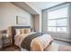 Comfortable bedroom with neutral tones, plush bedding, and a window for natural light at 7928 E 54Th Pl, Denver, CO 80238