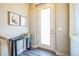 Inviting entryway with sleek console table, art, and modern finishes create a welcoming first impression at 7928 E 54Th Pl, Denver, CO 80238