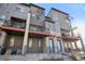 Modern townhouse exterior with private balconies and stylish architectural details at 7928 E 54Th Pl, Denver, CO 80238