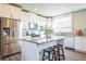 Bright kitchen features stainless steel appliances, granite countertops, and a central island with seating at 7928 E 54Th Pl, Denver, CO 80238