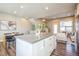 Bright open-concept kitchen featuring a center island with granite countertops and modern finishes at 7928 E 54Th Pl, Denver, CO 80238