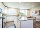 Well-lit kitchen with white cabinetry, granite countertops, and stainless steel appliances at 7928 E 54Th Pl, Denver, CO 80238