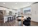 Modern kitchen features stainless steel appliances, granite countertops, and an adjacent dining area at 7928 E 54Th Pl, Denver, CO 80238