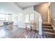 Open-concept living area with stairs, dining area, and kitchen, offering modern living space at 7928 E 54Th Pl, Denver, CO 80238