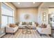 Inviting living room with plush seating, modern art, and neutral tones offer a relaxing atmosphere at 7928 E 54Th Pl, Denver, CO 80238