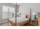 Bright bedroom with a wooden post bed and large window at 616 Scrubjay Cir, Castle Rock, CO 80104