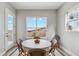 Cozy dining area with a round table and chairs near a window with a view at 616 Scrubjay Cir, Castle Rock, CO 80104