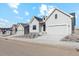 Modern farmhouse exterior, gray siding, two-car garage, and landscaping at 616 Scrubjay Cir, Castle Rock, CO 80104