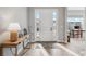 Bright foyer with hardwood floors, a console table, and a front door with sidelights at 616 Scrubjay Cir, Castle Rock, CO 80104