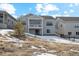 Gray two-story home with a deck and snowy yard at 616 Scrubjay Cir, Castle Rock, CO 80104