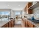 Open concept kitchen with granite countertops and stainless steel appliances at 616 Scrubjay Cir, Castle Rock, CO 80104