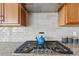 Kitchen detail showing gas cooktop and light gray backsplash at 616 Scrubjay Cir, Castle Rock, CO 80104