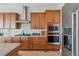 Modern kitchen with stainless steel appliances and light wood cabinets at 616 Scrubjay Cir, Castle Rock, CO 80104