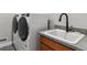 White washer and dryer with a utility sink in the laundry room at 616 Scrubjay Cir, Castle Rock, CO 80104