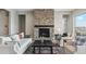 Cozy living room showcasing a stone fireplace, hardwood floors, and stylish furnishings at 616 Scrubjay Cir, Castle Rock, CO 80104