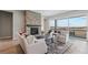 Bright living room with a stone fireplace, hardwood floors, and a sliding glass door to the deck at 616 Scrubjay Cir, Castle Rock, CO 80104