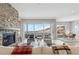 Inviting living room featuring a stone fireplace, large windows, and comfortable seating at 616 Scrubjay Cir, Castle Rock, CO 80104