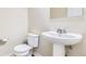 Bathroom features a pedestal sink, toilet, and neutral color palette at 2356 W 165Th Pl, Broomfield, CO 80023