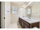 Bathroom features double sinks with dark wood cabinets, a large mirror, and neutral colors at 2356 W 165Th Pl, Broomfield, CO 80023