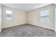 Bright bedroom featuring neutral walls, plush gray carpet, and natural light from two windows at 2356 W 165Th Pl, Broomfield, CO 80023
