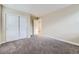 Bedroom featuring neutral walls, plush gray carpet, and a closet with sliding doors at 2356 W 165Th Pl, Broomfield, CO 80023