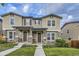 Charming townhome with stone accents, covered porch, and well-manicured front lawn at 2356 W 165Th Pl, Broomfield, CO 80023