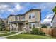 Townhome exterior featuring stone accents, a covered porch, and a green lawn at 2356 W 165Th Pl, Broomfield, CO 80023
