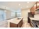 Modern kitchen with stainless appliances, a center island with sink, and an open concept to the living room at 2356 W 165Th Pl, Broomfield, CO 80023