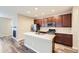 Modern kitchen features stainless appliances, an island with sink, and attractive wood cabinets at 2356 W 165Th Pl, Broomfield, CO 80023