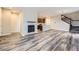 Spacious living room with a fireplace, wood floors, and an open layout leading to the kitchen at 2356 W 165Th Pl, Broomfield, CO 80023