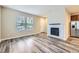 Bright living room with wood floors, a fireplace, and large windows offering natural light at 2356 W 165Th Pl, Broomfield, CO 80023